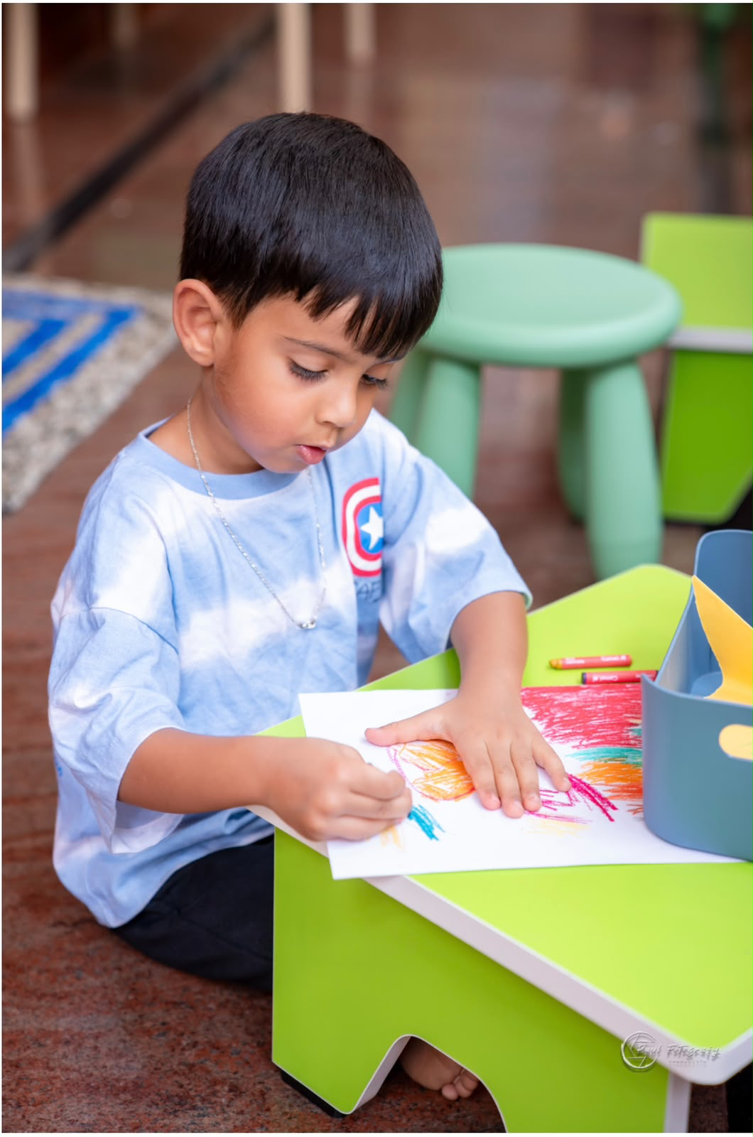 A child drawing during art time at Tender Moments Hebbal